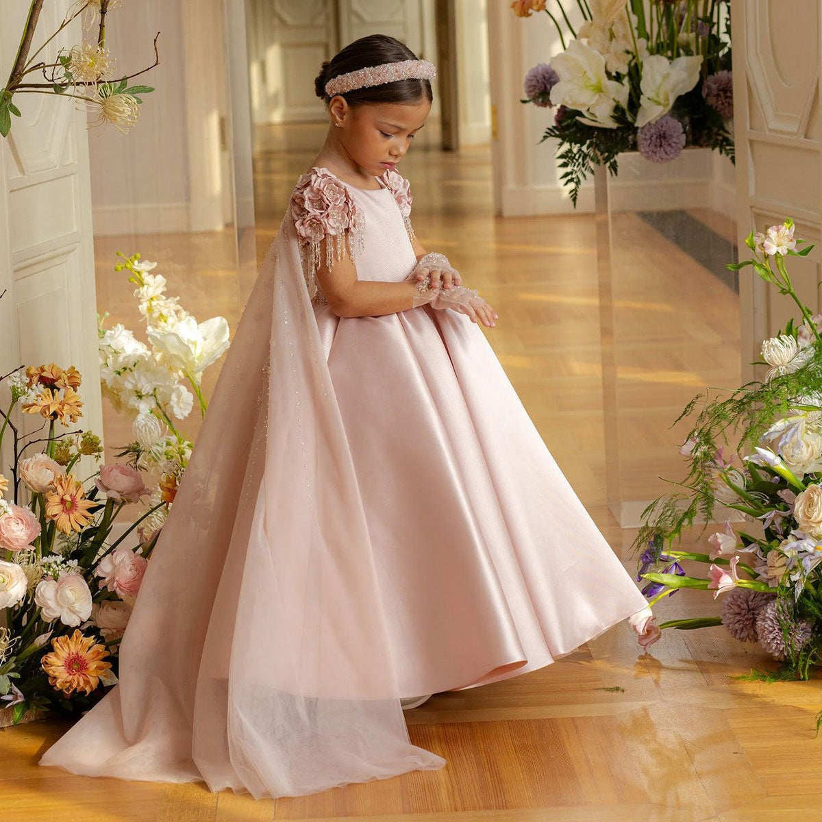 Dusty pink flower girl dress with cap sleeves and beaded bodice for a garden wedding