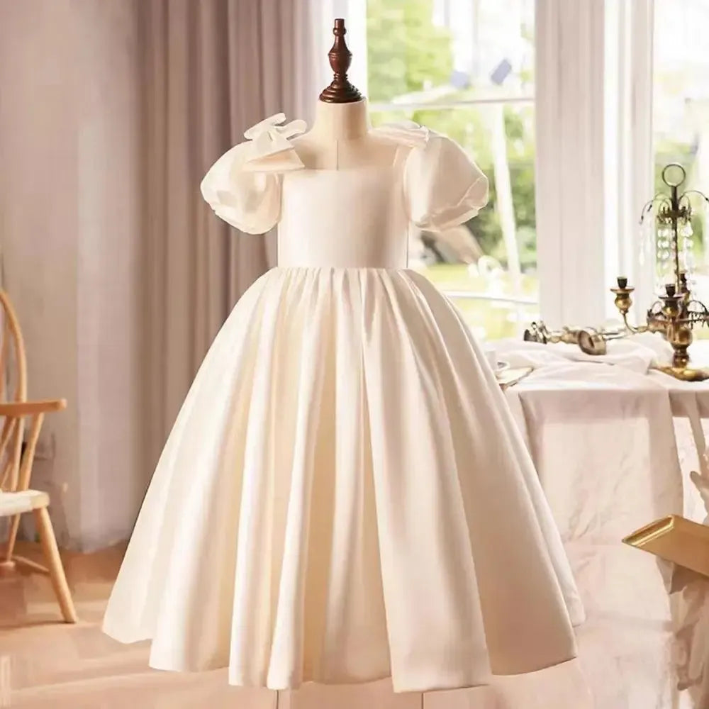 White flower girl dress with bow detail for classic wedding styling