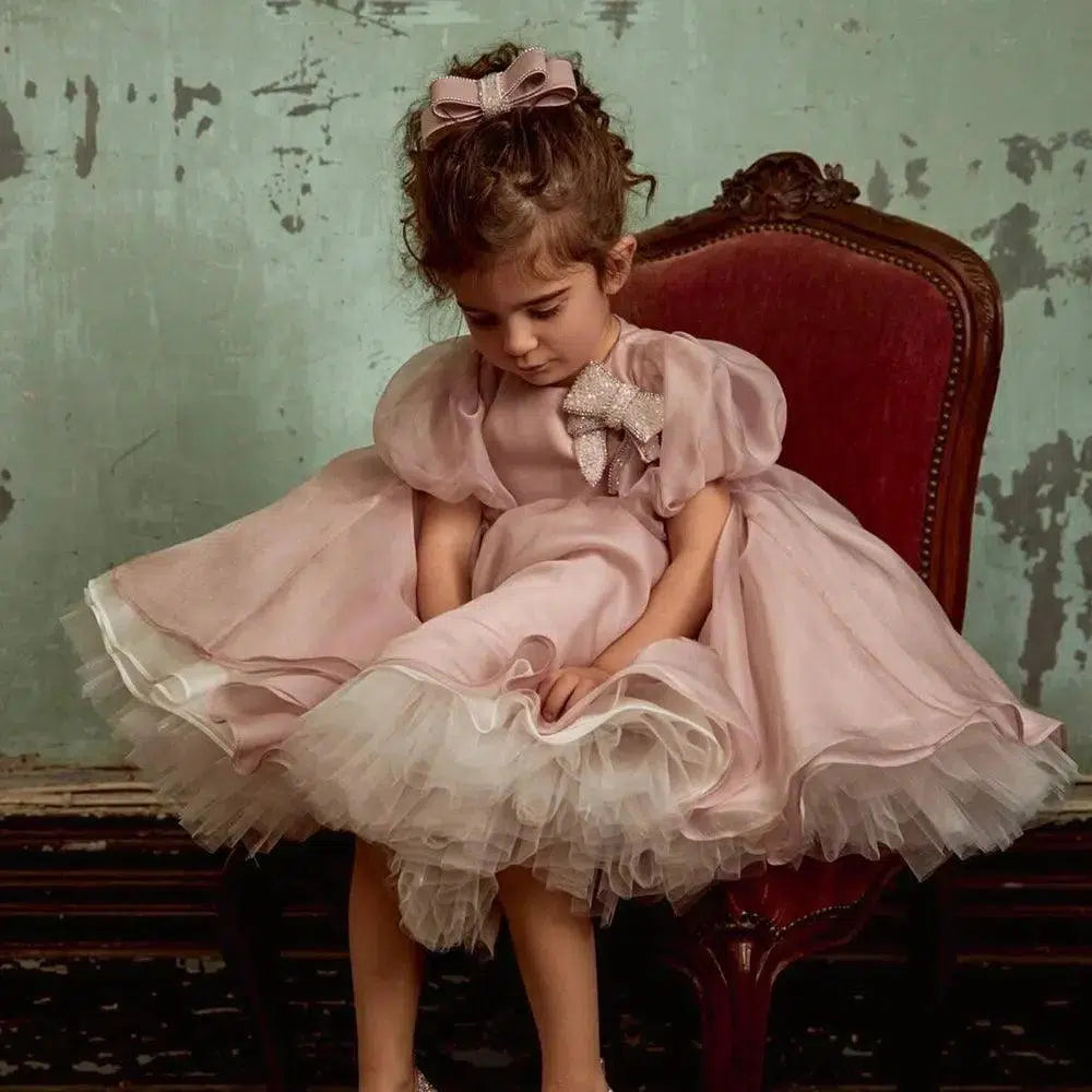 Dusty pink flower girl dress with bow styling for younger sisters
