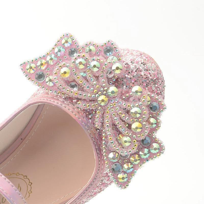 Detail of girls' pink rhinestone butterfly shoes